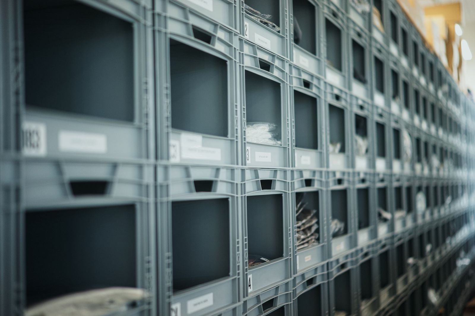 Racks of storage bins in the Flagship24 warehouse in Prague